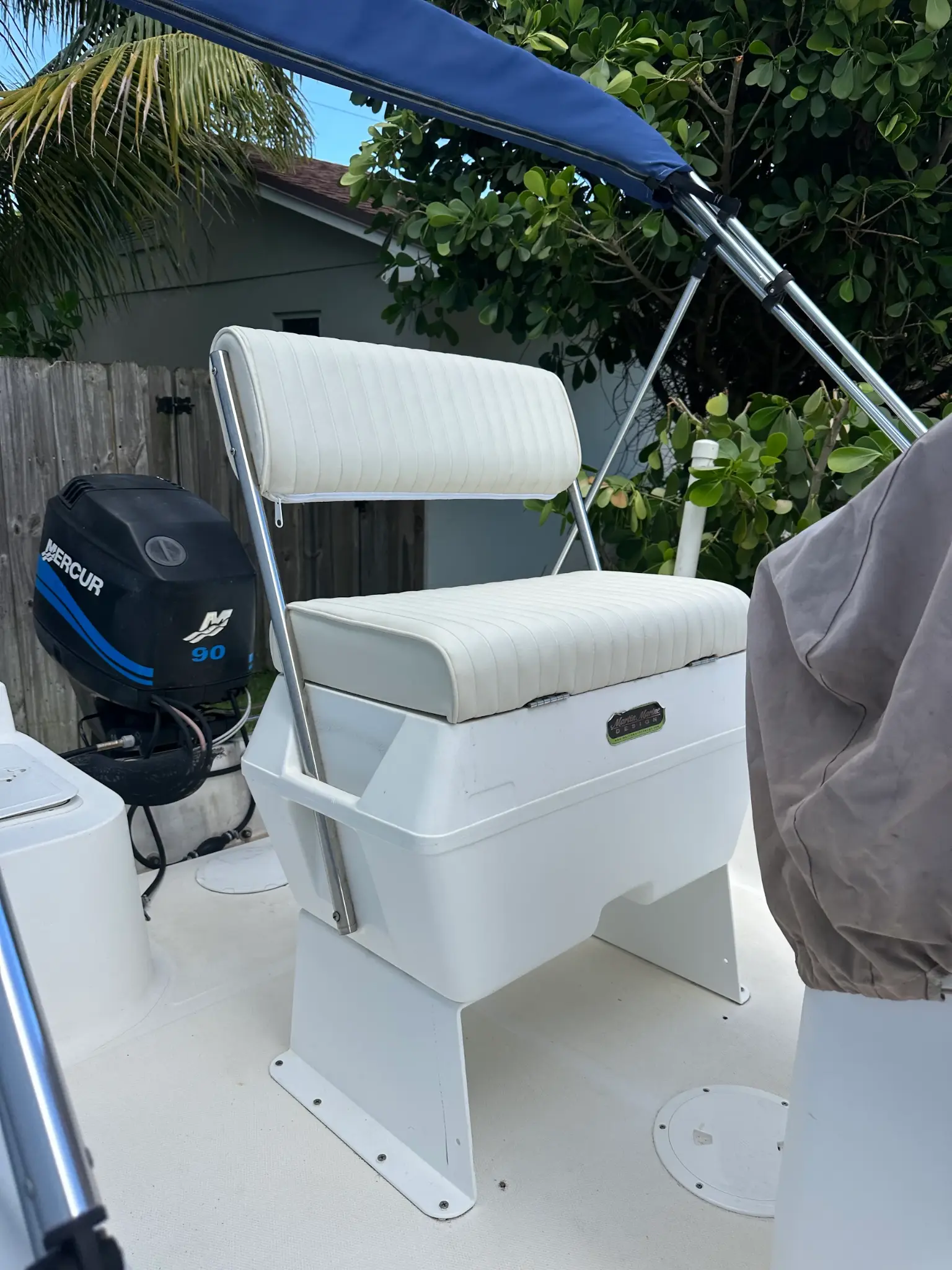 Boat captain seat with blue bimini top