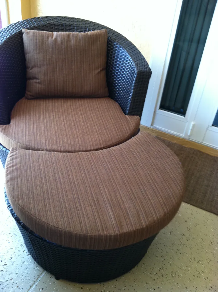 Custom reupholstered outdoor patio chair with marine-grade fabric by Hobe Sound Canvas
